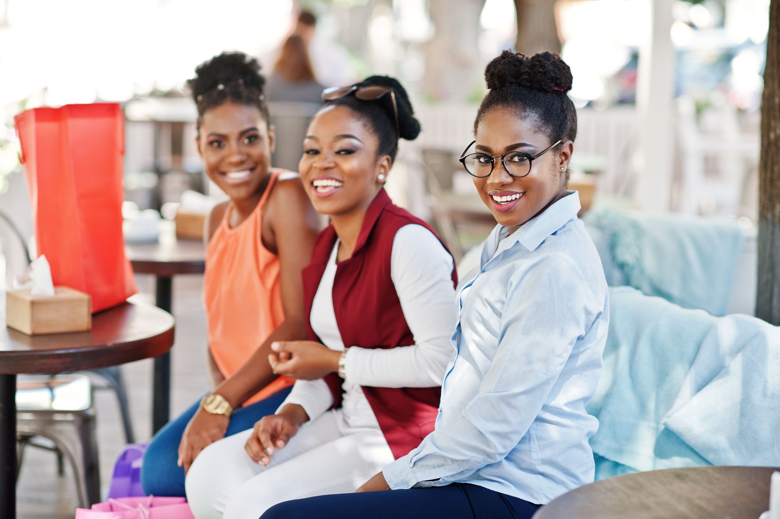 https://realtyprosnig.com/wp-content/uploads/2024/07/three-casual-african-american-girls-with-colored-shopping-bags-walking-outdoor-stylish-black-womans-shopping2-scaled.jpg